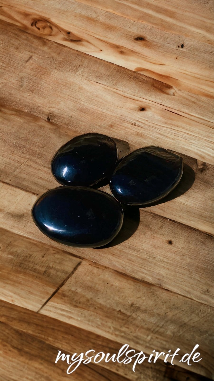 3 schwarze Obsidian Seifensteine auf Holzdekoration